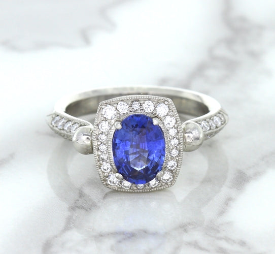 1.56ct Oval Blue Sapphire Ring with Diamond Halo in Platinum