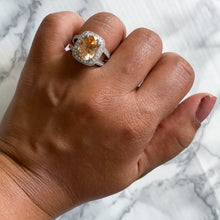Load image into Gallery viewer, 6.58ct Oval Orangey Peach Sapphire with diamond halo in 18K White Gold
